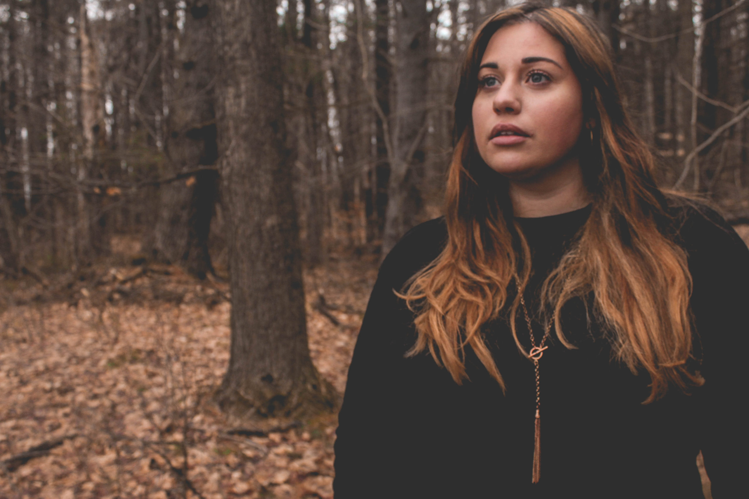 Cass in the forest looking moody